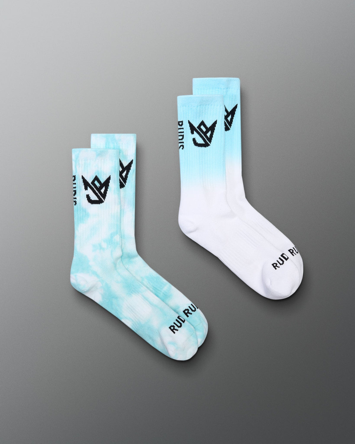 Two gradient socks with cloud design and brand logo on a gray background