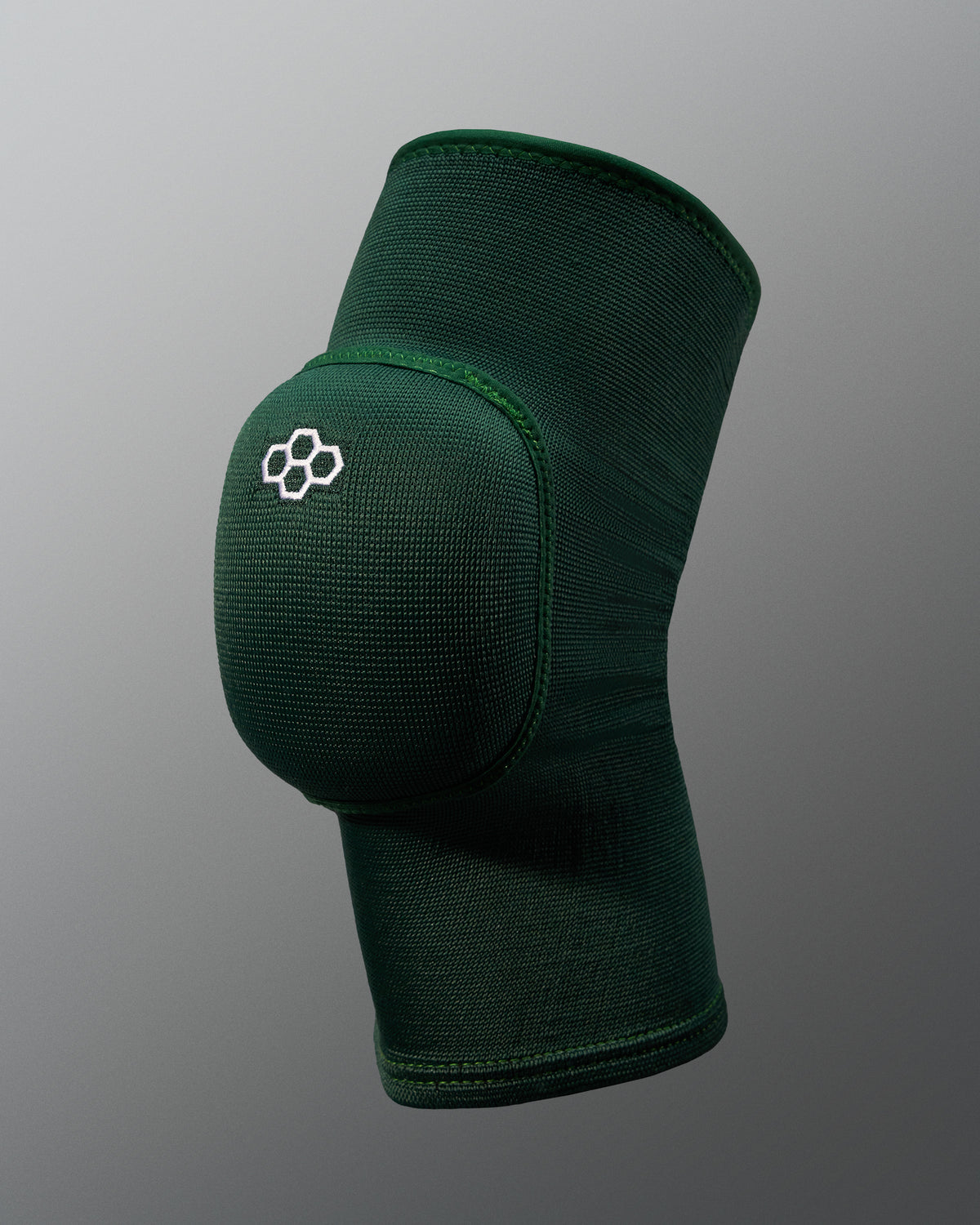 Green knee pad with a logo on a gray background