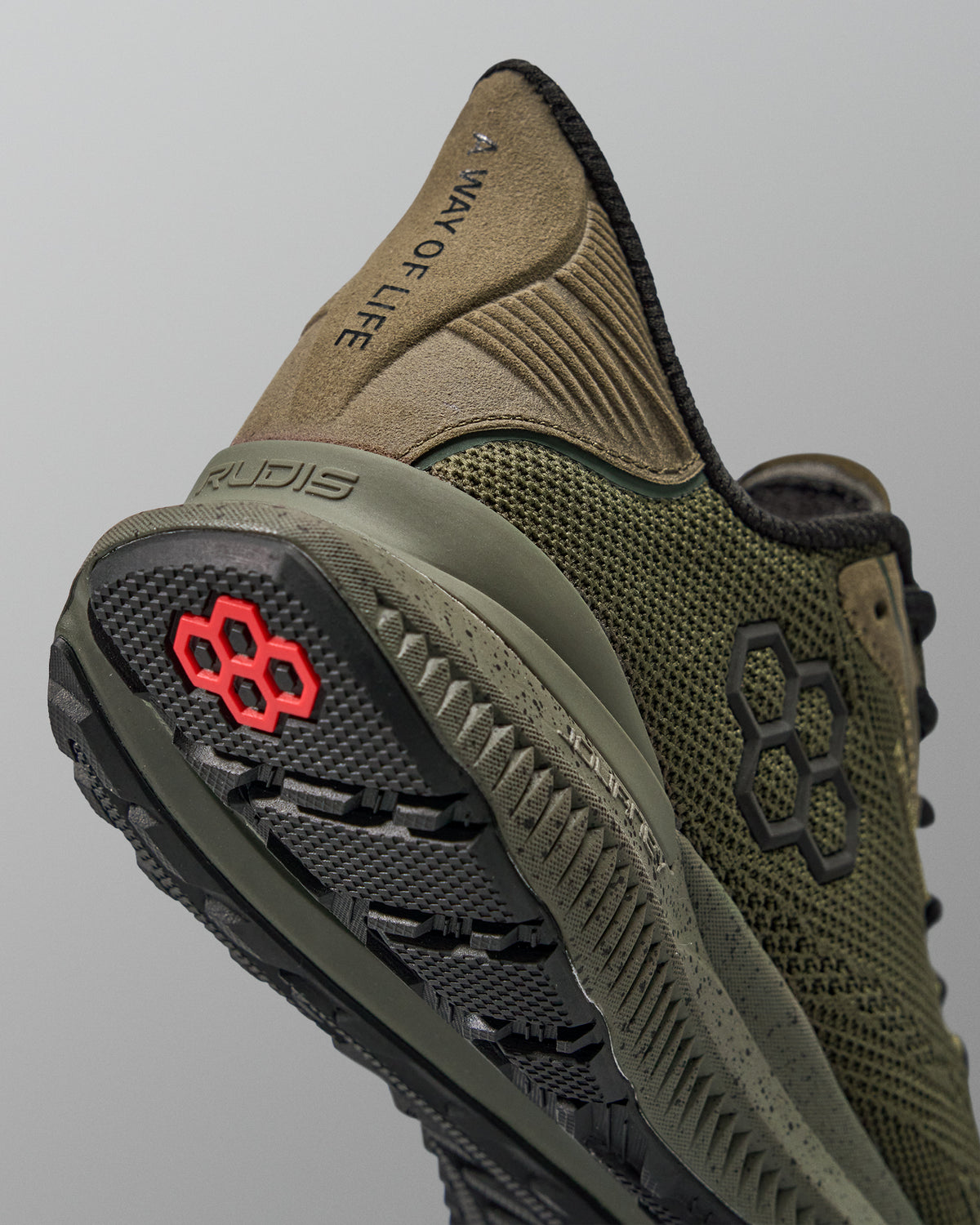 Green training shoe with black sole and red logo on a gray background