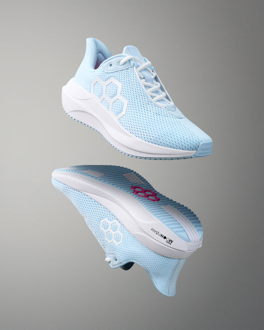 Light blue running shoe with white sole on a gray background