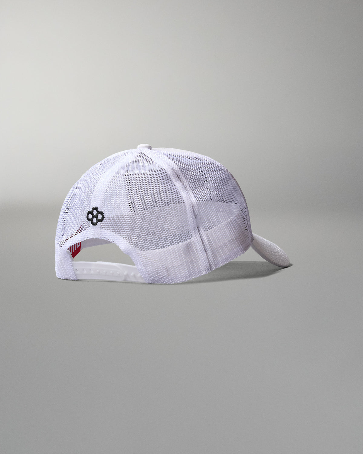 White mesh cap with a small logo on a gray background