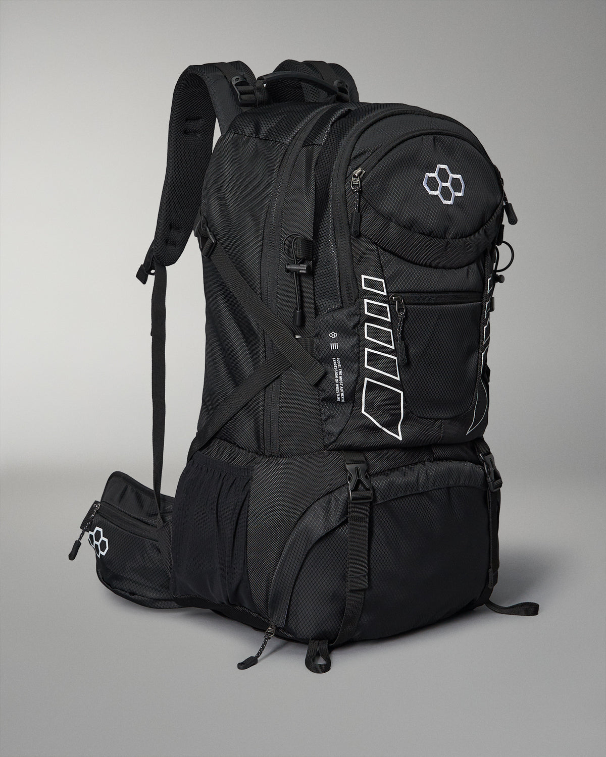 A sleek black wrestling backpack with multiple compartments and adjustable padded straps features white accents and a logo, set against a gray background.