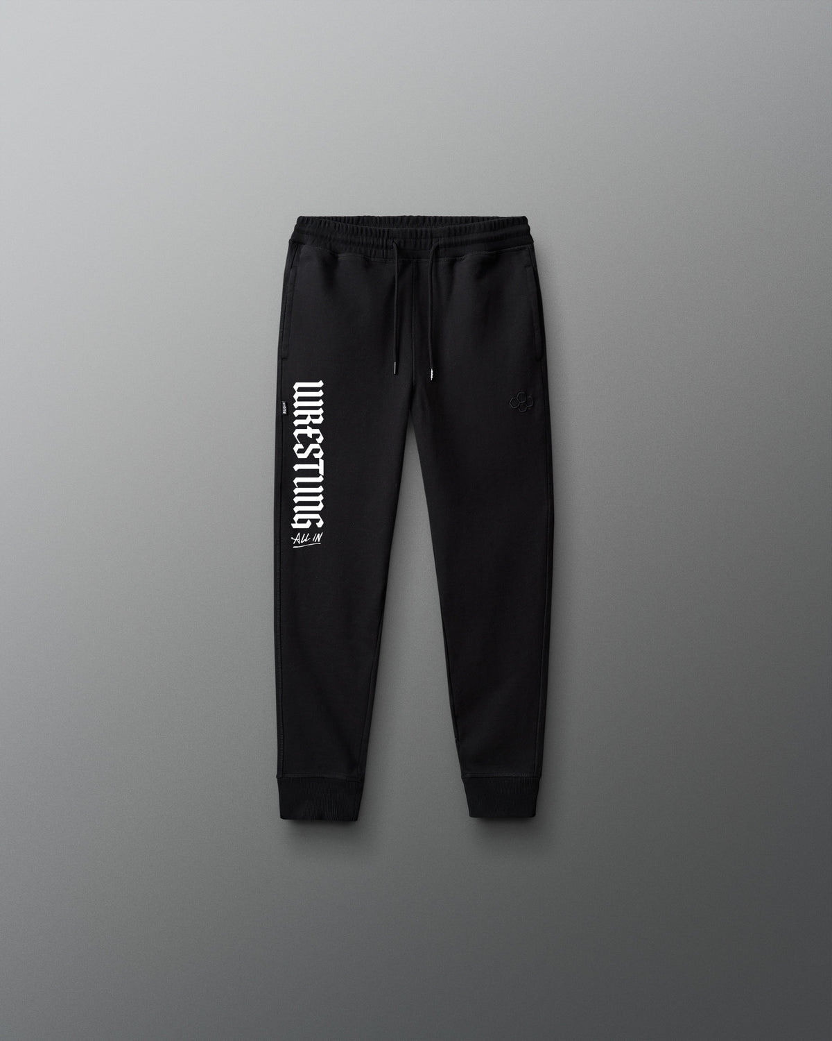 Black sweatpants with white text on a gray background