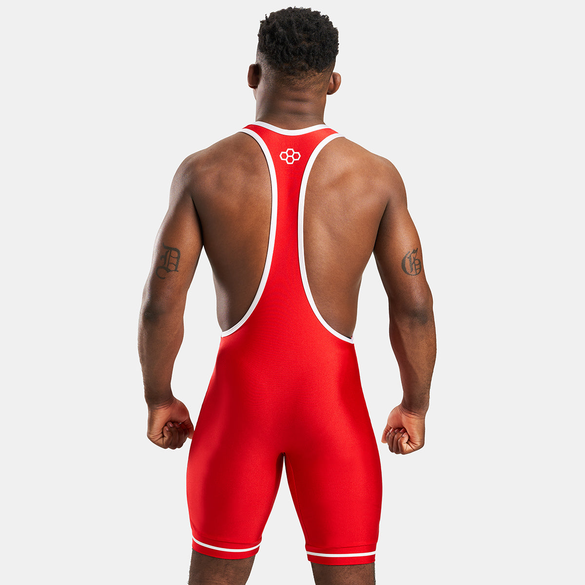 A muscular man wearing a red wrestling singlet with white trim showcasing a dynamic athletic pose from the back