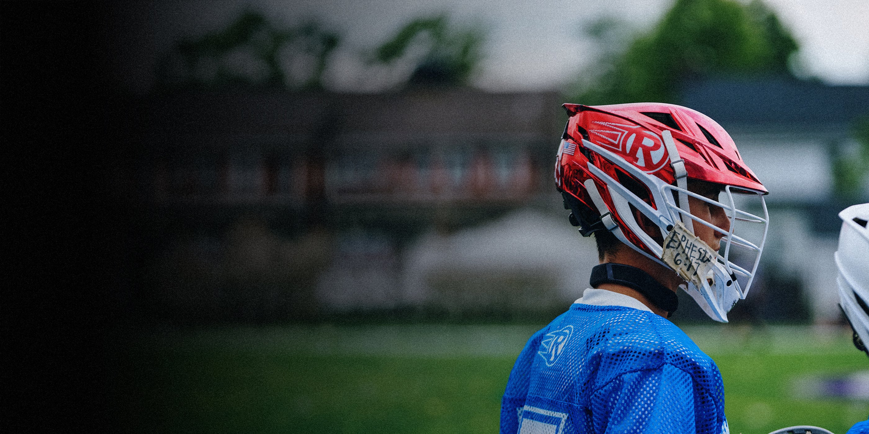 Athlete wearing Resolute Lacrosse × RUDIS performance apparel and lacrosse equipment before practice, highlighting elite competition and team training.
