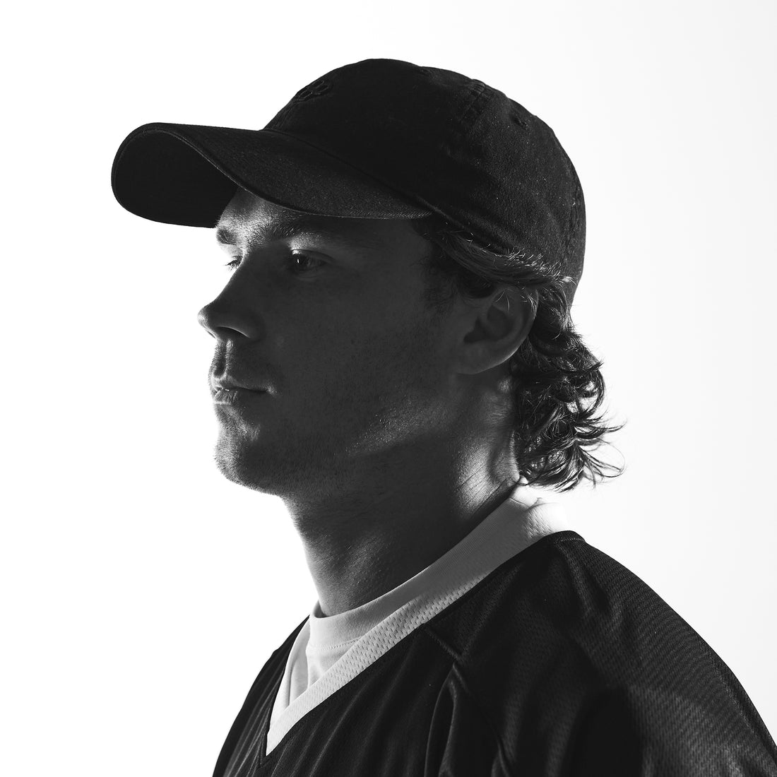 Pat Kavanagh, RUDIS lacrosse athlete, featured in a black-and-white portrait wearing RUDIS lacrosse apparel. 