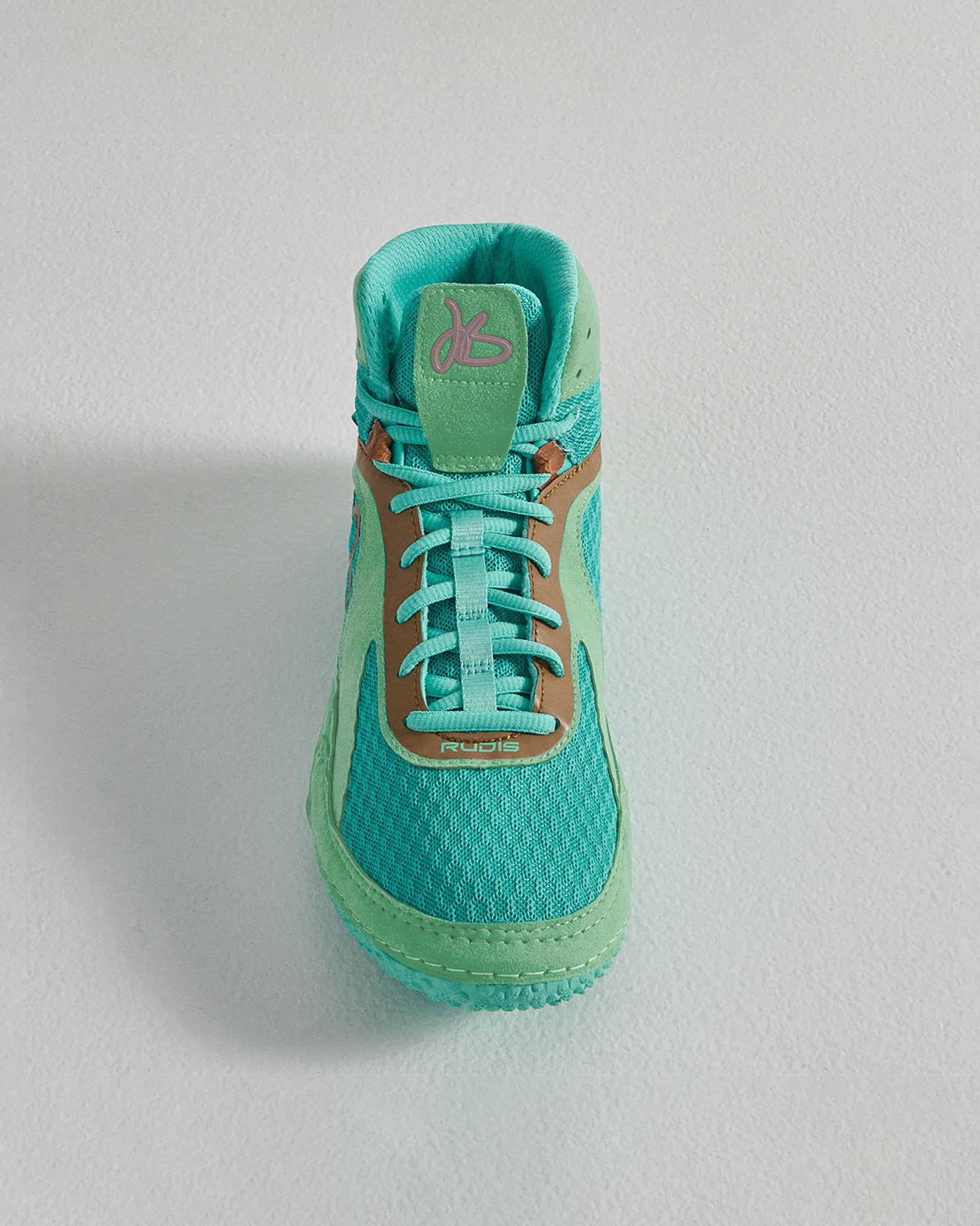 A vibrant turquoise athletic shoe with a breathable mesh upper featuring a sleek design and highlighted by a brown accent near the laces
