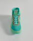 A vibrant turquoise athletic shoe with a breathable mesh upper featuring a sleek design and highlighted by a brown accent near the laces