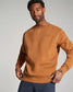 A man is wearing a stylish brown sweatshirt with a casual fit showcasing a simple design that is both modern and comfortable