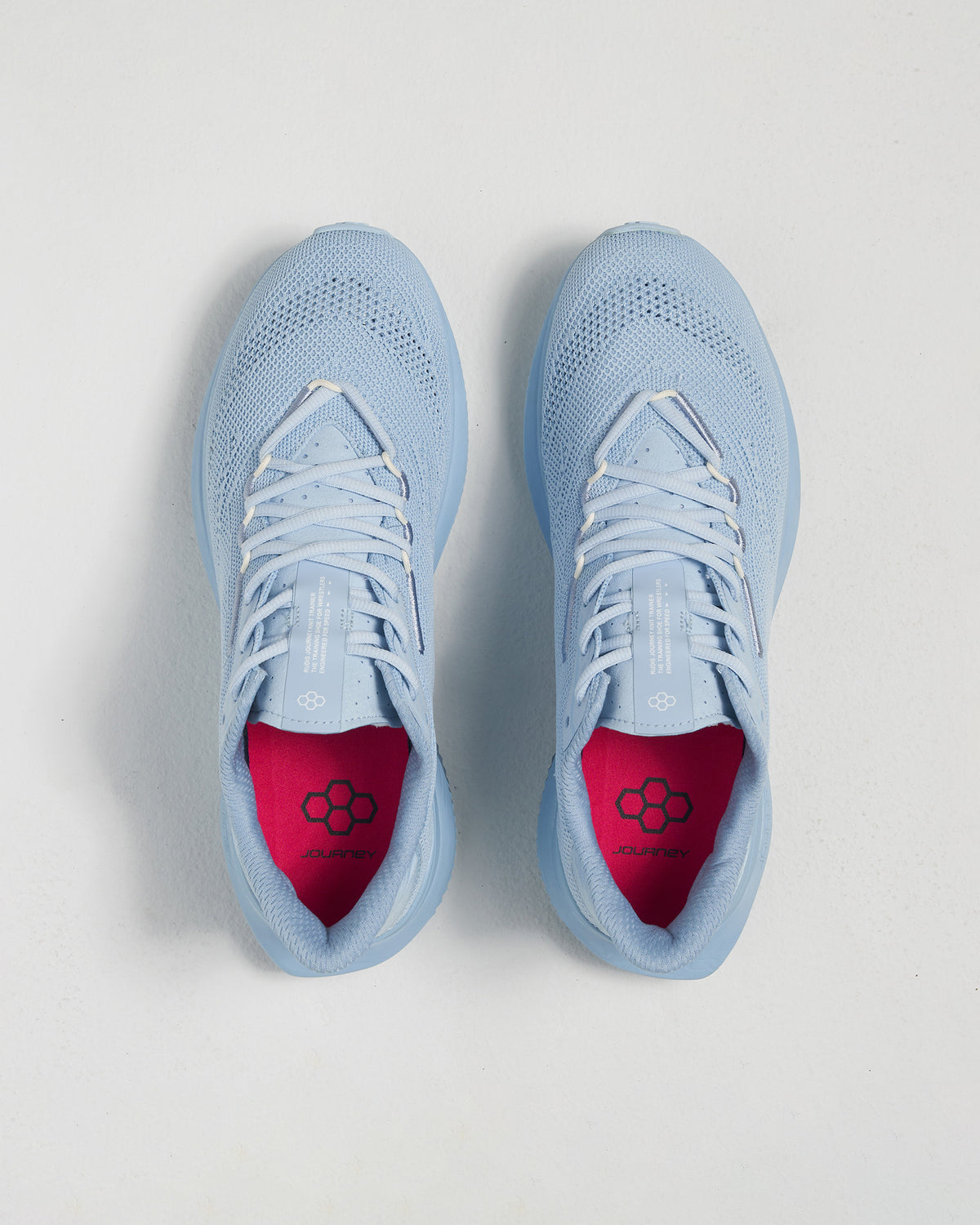 A pair of light blue athletic shoes featuring a breathable mesh upper and a vibrant pink interior designed for comfort and style