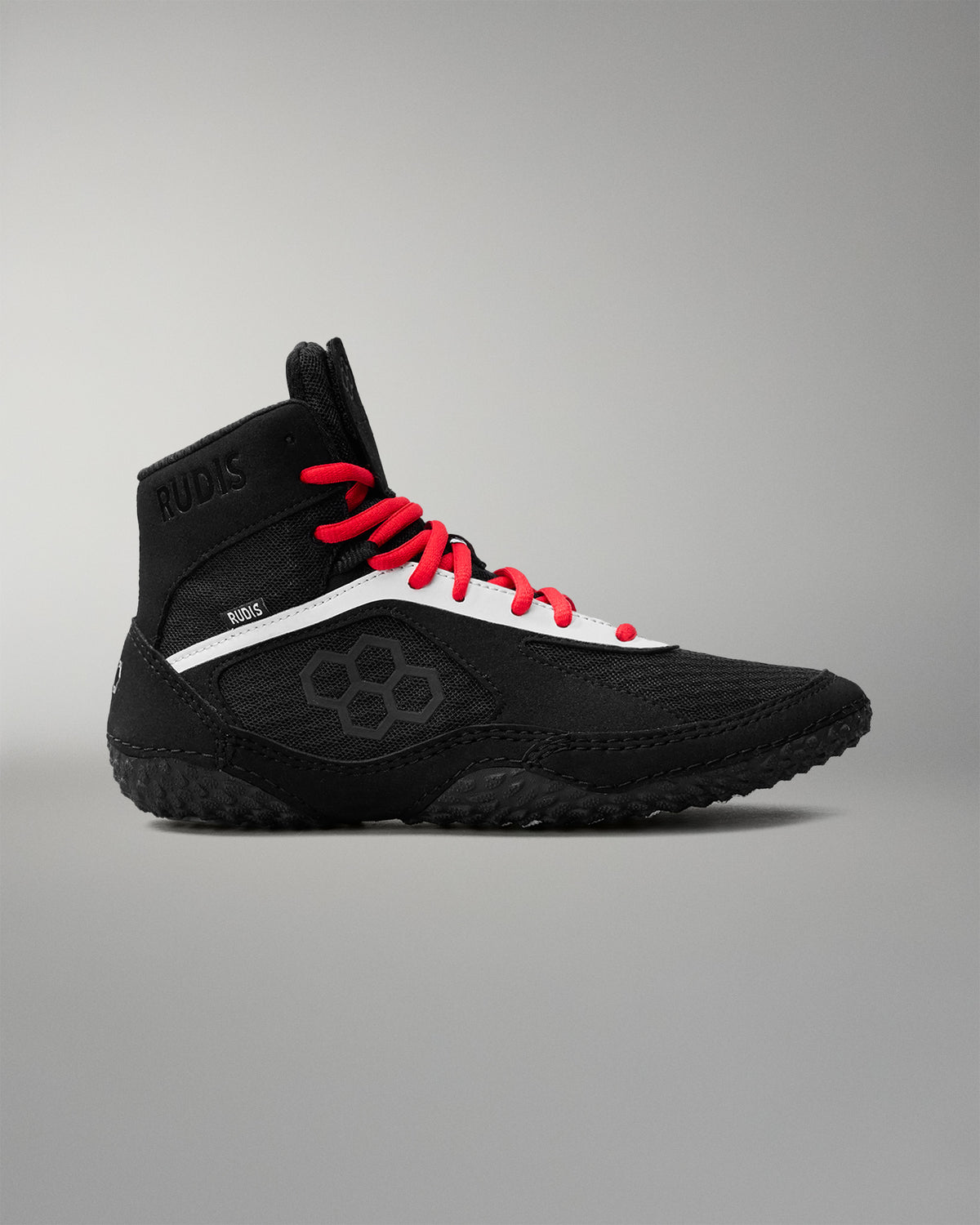 Black wrestling shoe with red laces on a gray background