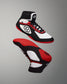Wrestling shoe in white, black, and red, featuring a breathable mesh upper, padded collar, and textured red and black sole designed for grip.