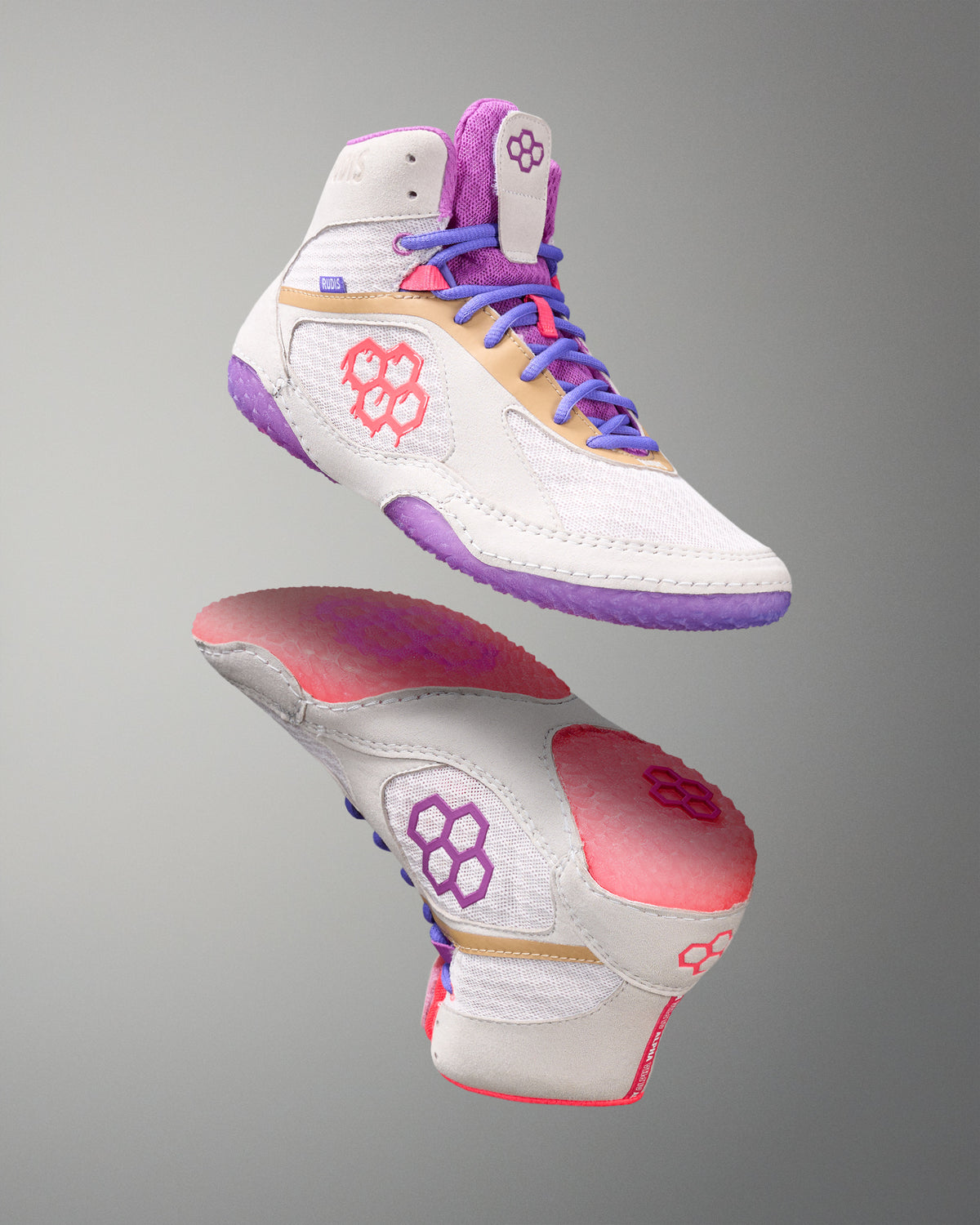 Colorful wrestling shoes with white, purple, pink, and red accents on a gray background