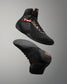 Black high-top sneakers with orange accents on a gray background