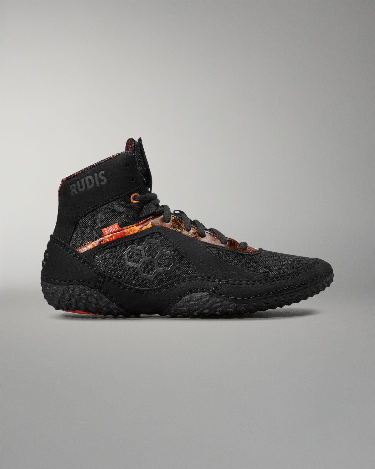 Black athletic shoe with visible branding on a gray background