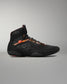 Black athletic shoe with visible branding on a gray background