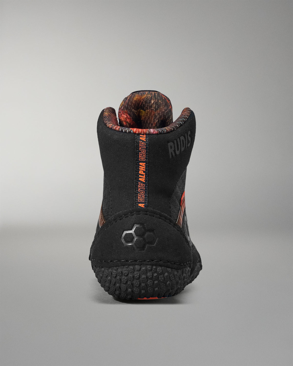 Black and orange boot with visible branding on a gray background