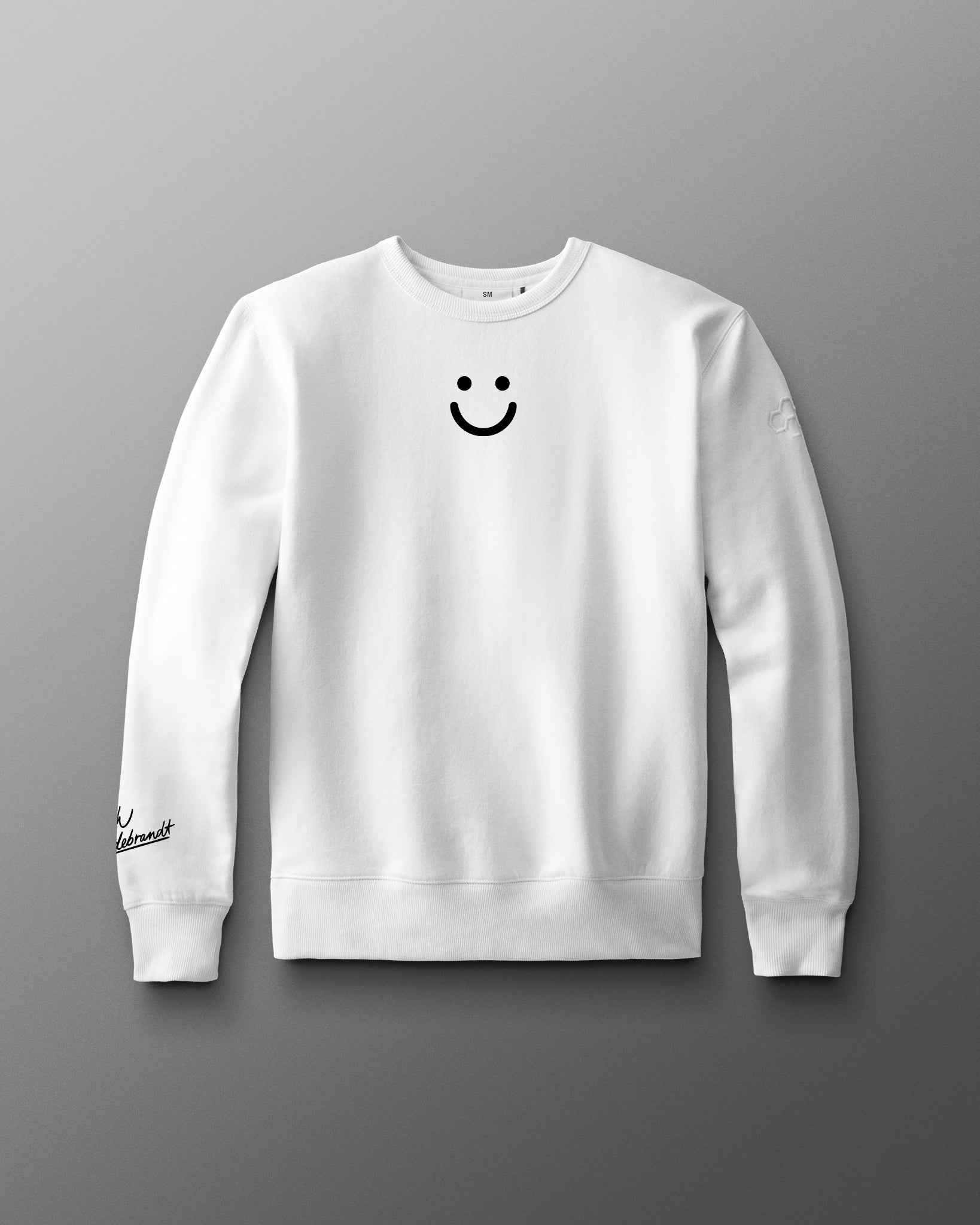White sweatshirt with a smiley face design on a gray background