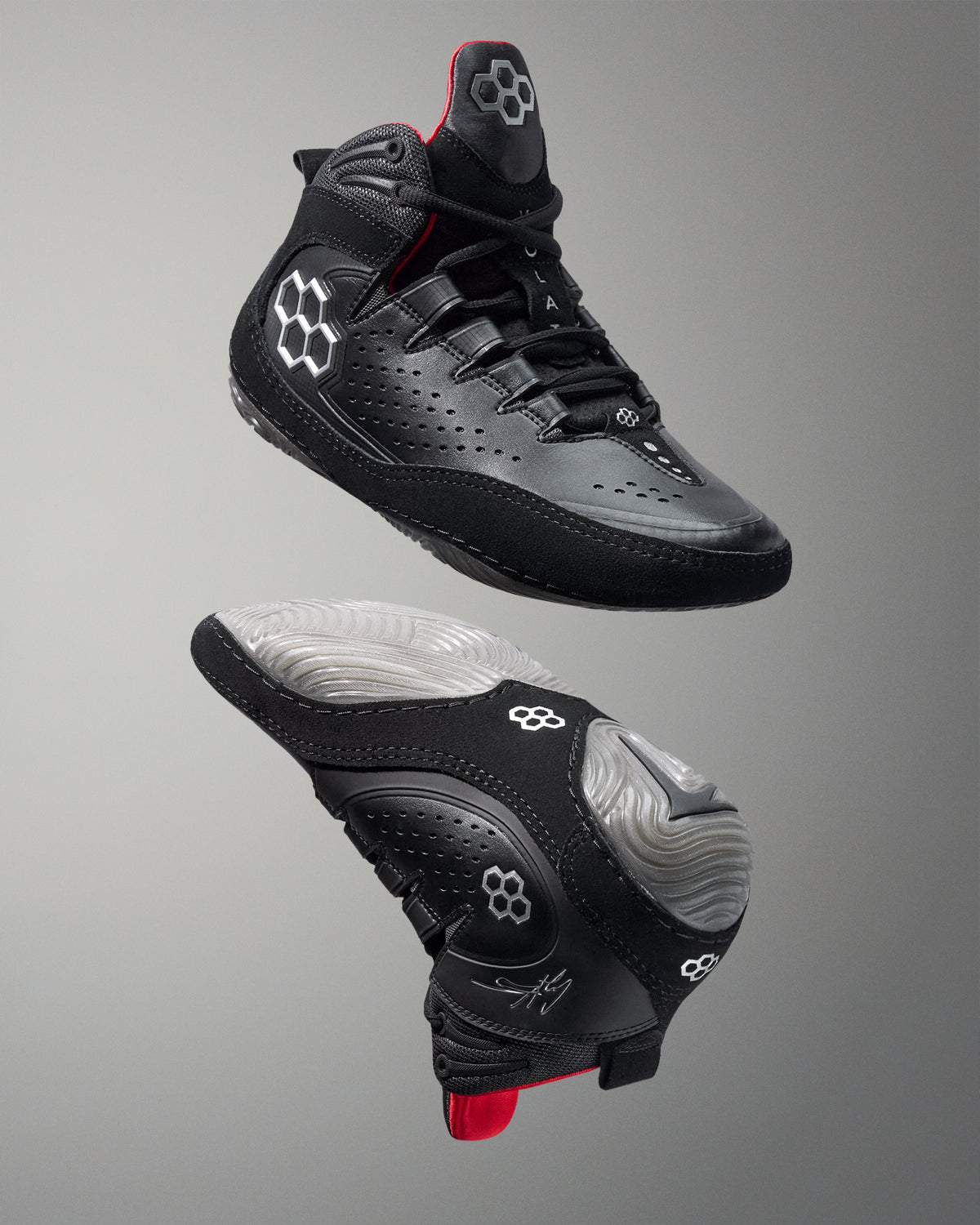 Black wrestling shoe with red accents on a gray background - Cary Kolat wrestling shoes