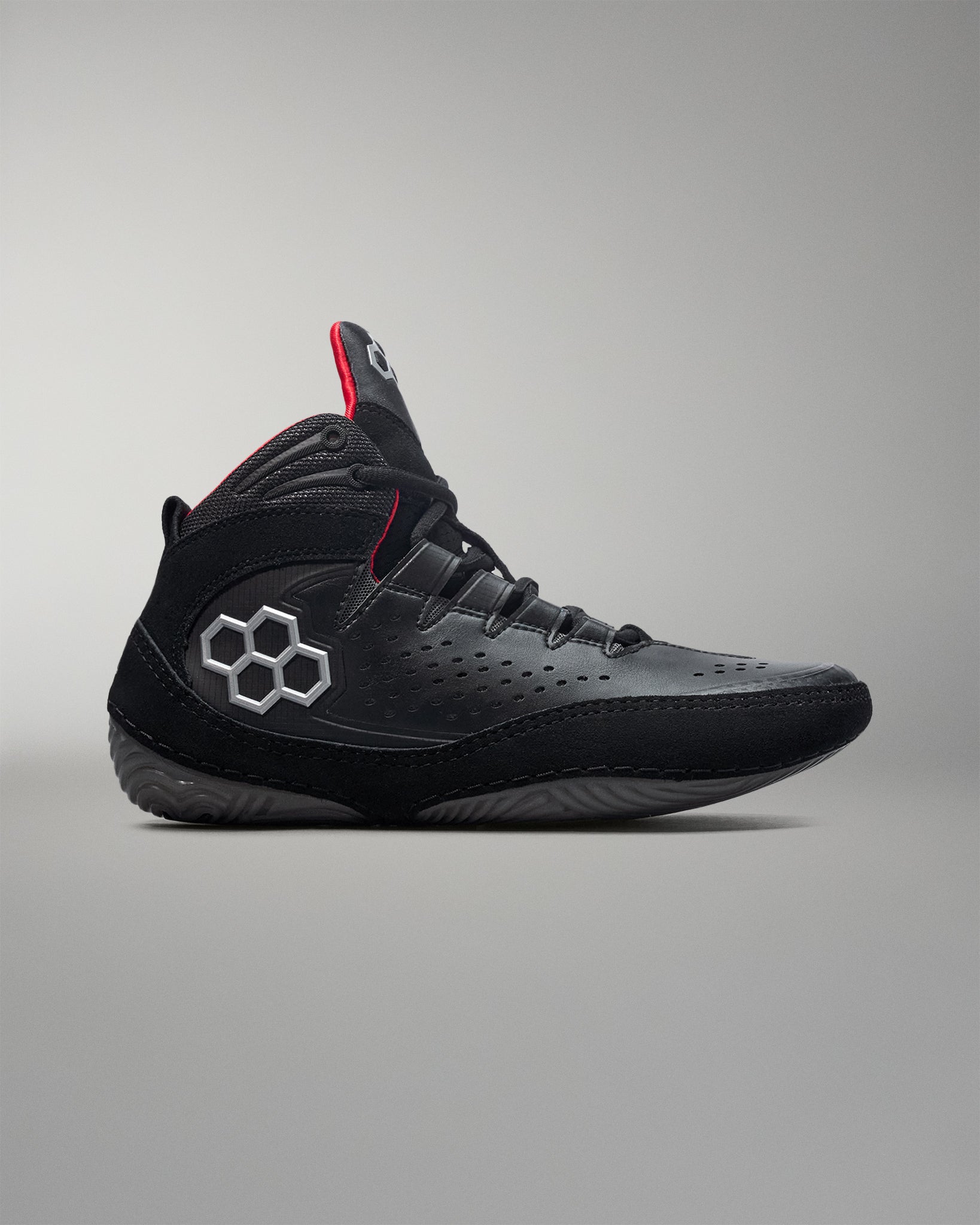 Black wrestling shoe with a unique logo on a gray background - Cary Kolat wrestling shoes