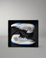 White and blue wrestling shoes in a black box on a gray background