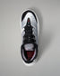 Black and white wrestling shoe on a gray background