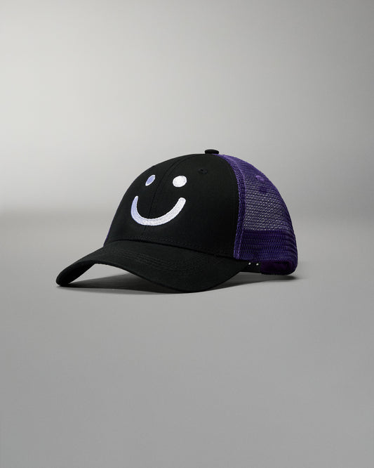 Black cap with purple mesh back and smiley face design on a gray background