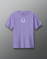 Purple t-shirt with a smiley face design on a gray background