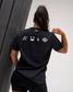 Back view of the RUDIS SH Smile Elite Super Soft T-Shirt in black, featuring white signature, smile, lightning bolt, and RUDIS graphics.