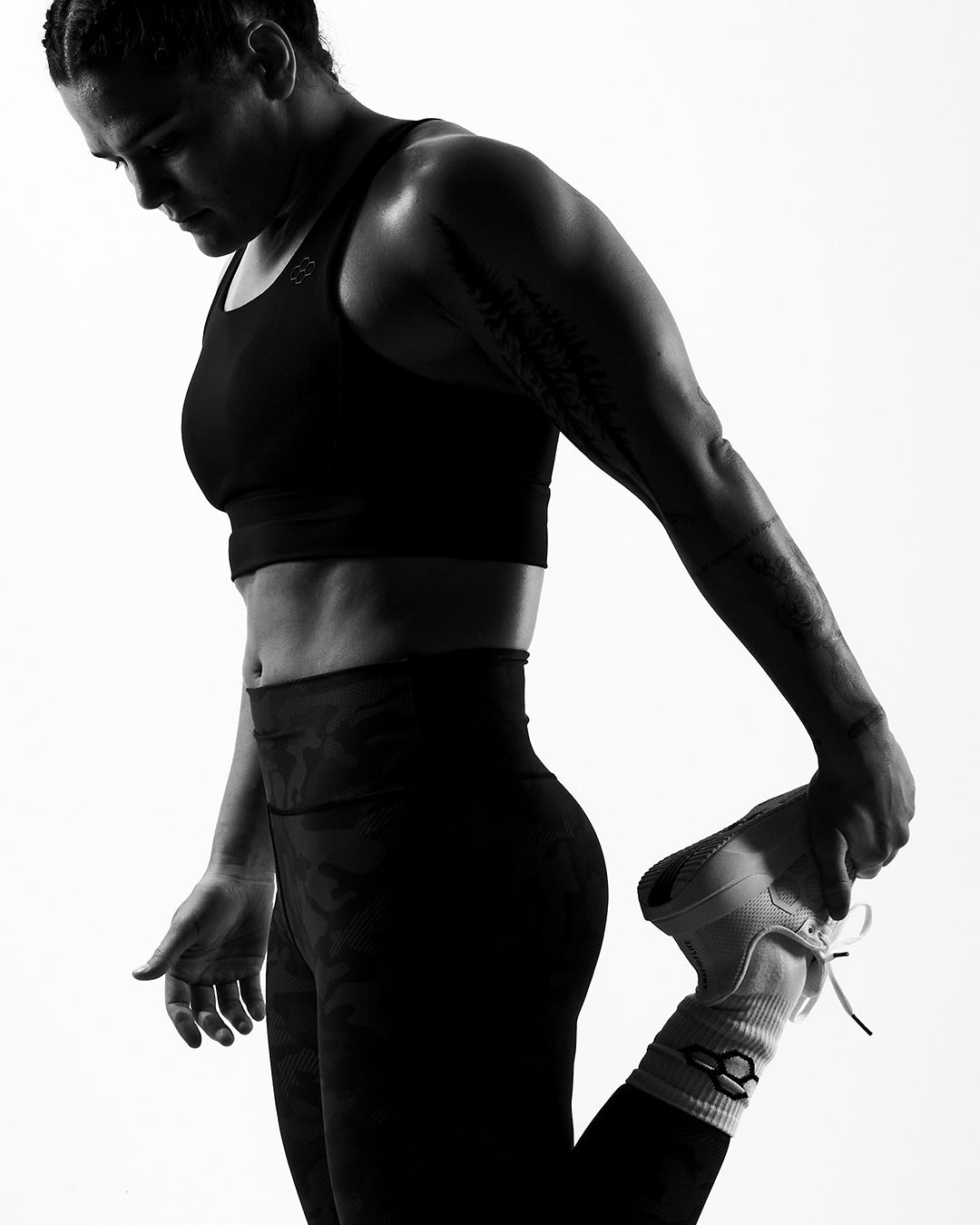 Kayla Miracle wearing RUDIS performance apparel and training shoes during a mobility warmup, highlighting athletic training, strength, and functional fitness.