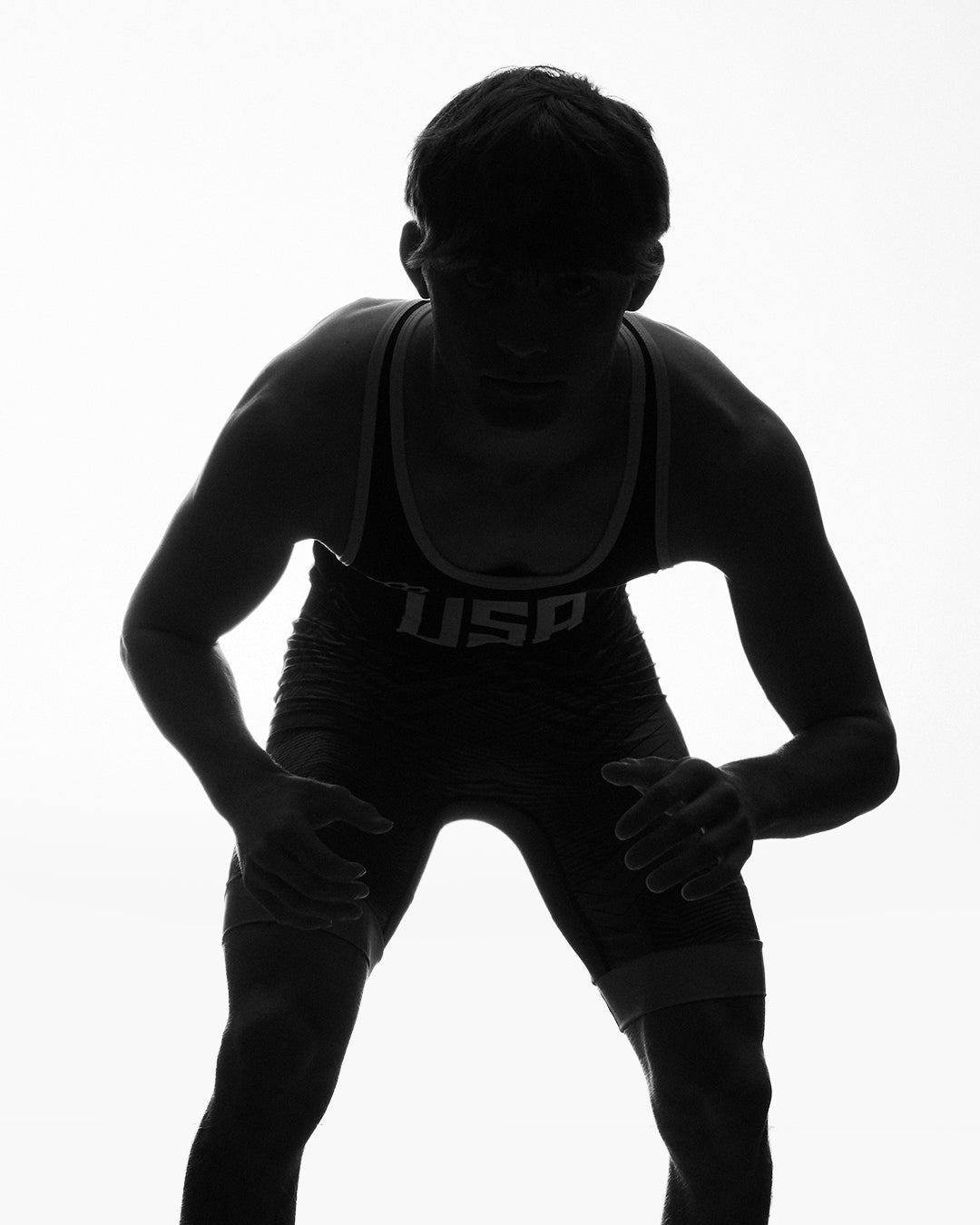 Marcus Blaze in a wrestling stance wearing RUDIS wrestling apparel, representing elite competition, speed, agility, and mat-ready performance.