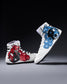White wrestling shoes with red and blue dragon designs on a dark background