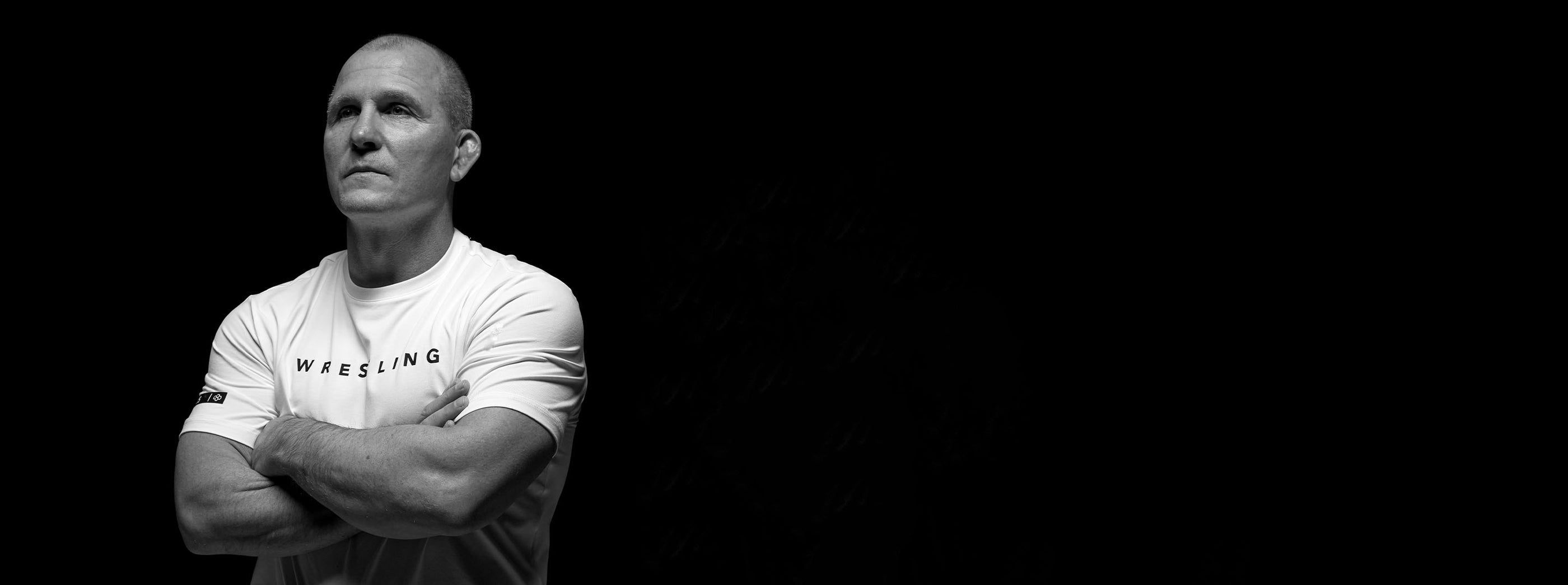 Cary Kolat portrait with arms crossed representing RUDIS wrestling legacy and elite performance mindset
