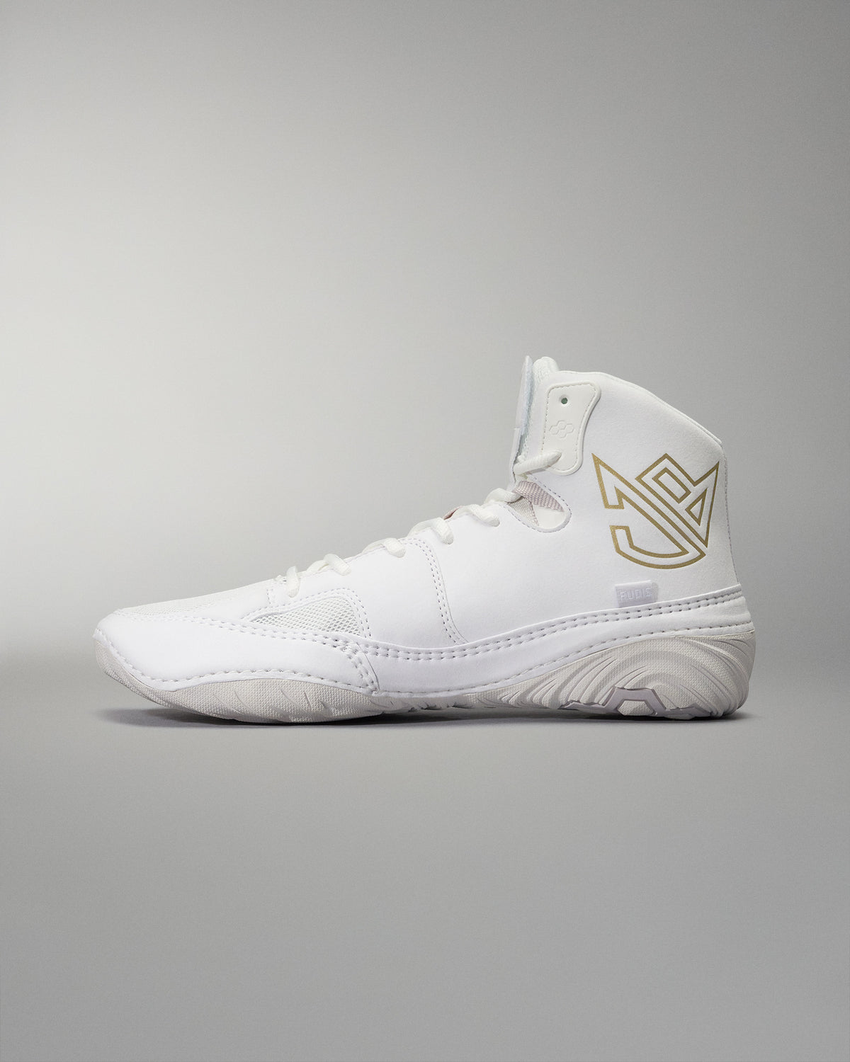 High-top athletic shoe presented in white with a textured sole, gold logo, and padded collar, designed for comfort and performance against a soft gray background.