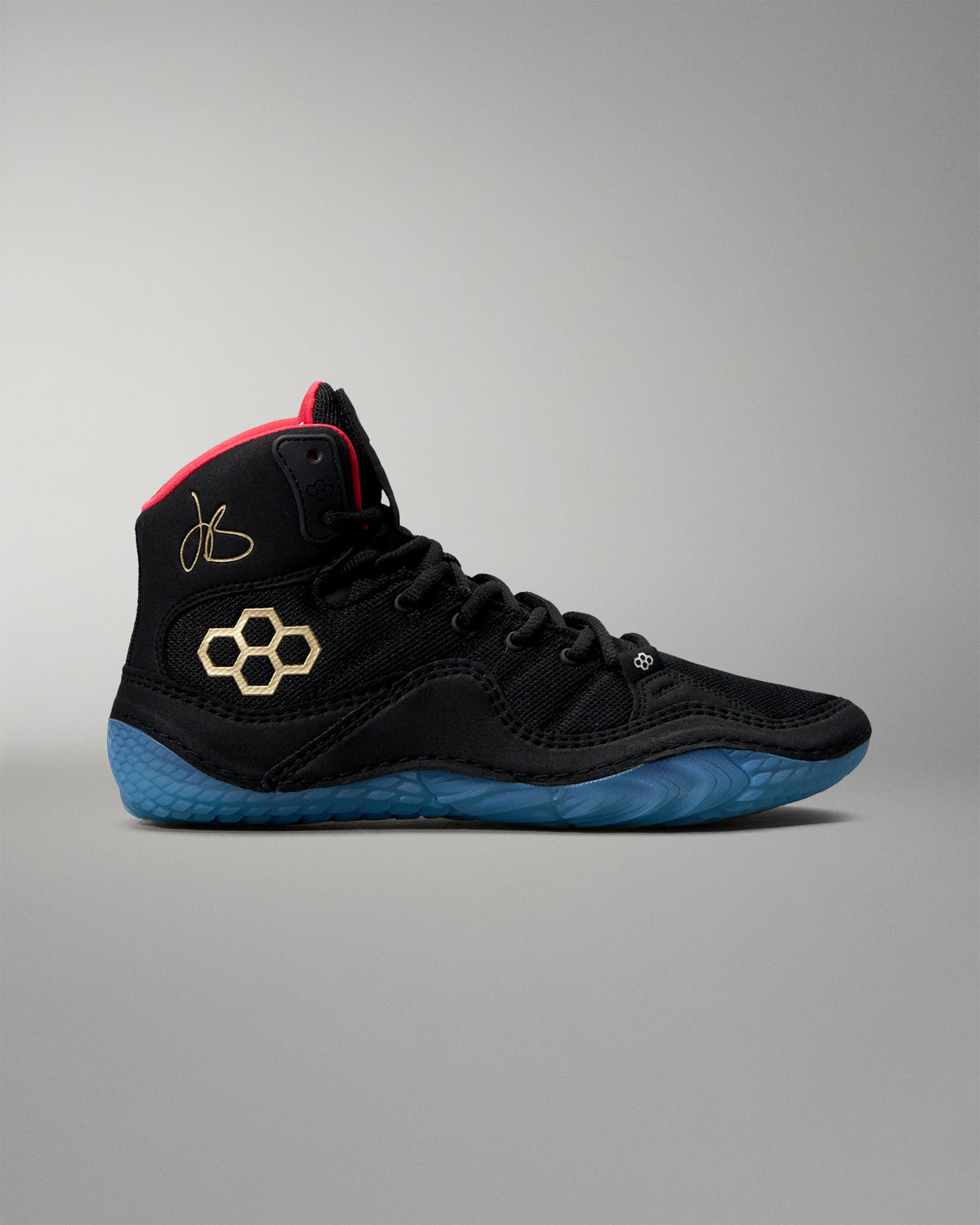 Black wrestling shoe with blue sole on a gray background