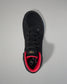 Black wrestling shoe with red lining on a gray background