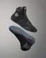 Black Jordan Burroughs wrestling shoes with brand logo on a gray background
