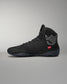 Black Jordan Burroughs wrestling shoes with a logo on a gray background
