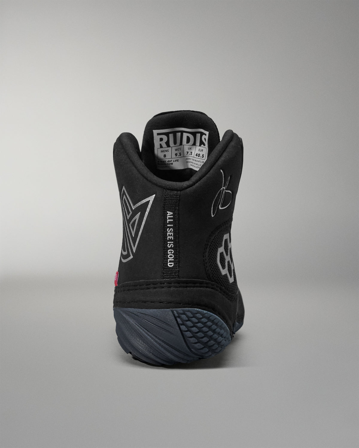 Black Jordan Burroughs wrestling shoes with text and branding on a gray background
