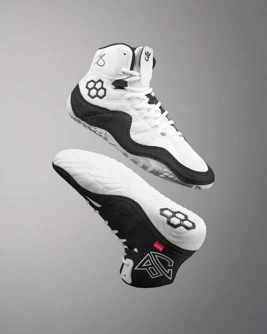 Black and white Jordan Burroughs Wrestling shoes with brand logo on a gray background