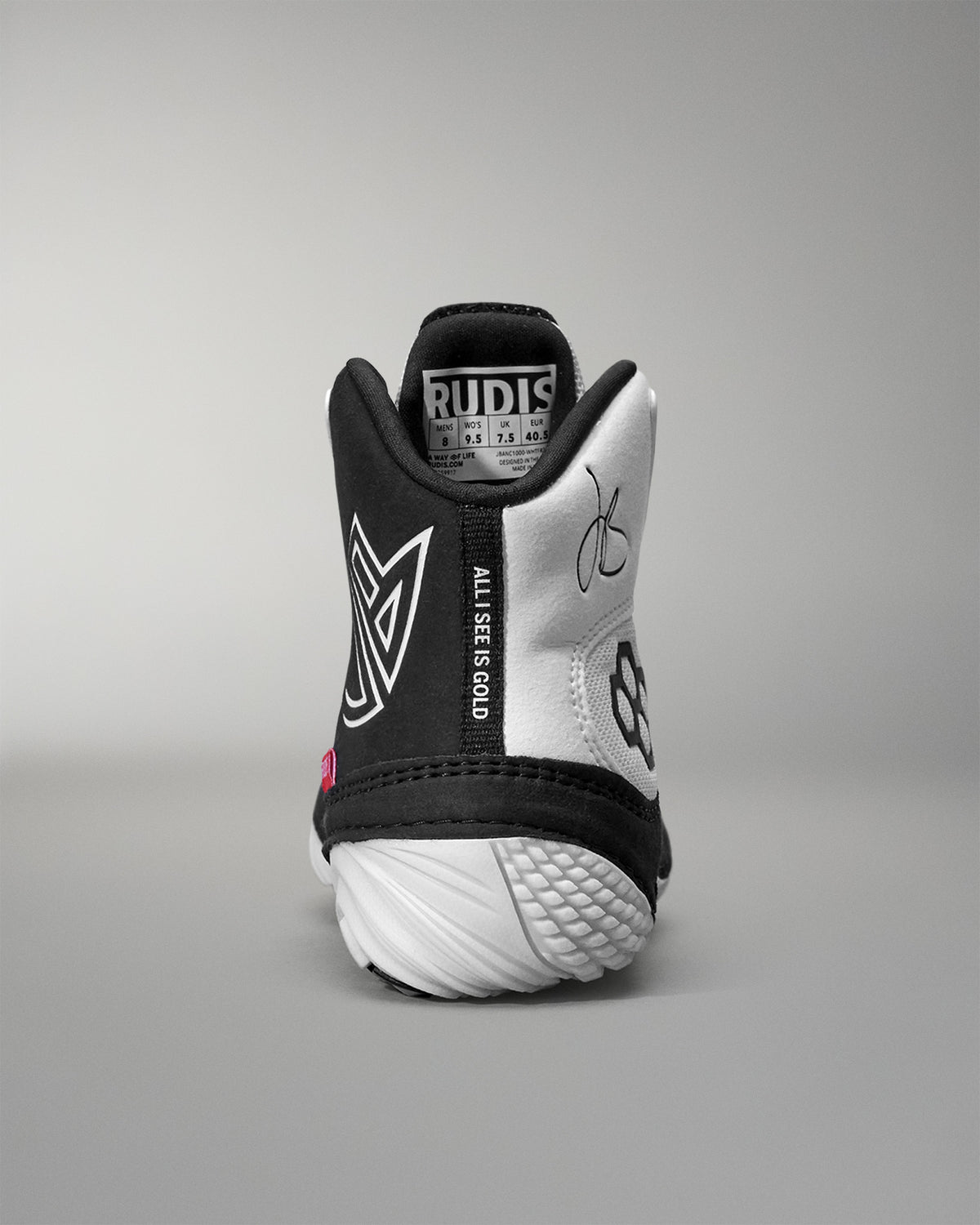 Black and white Jordan Burroughs Wrestling shoes with visible branding on a gray background