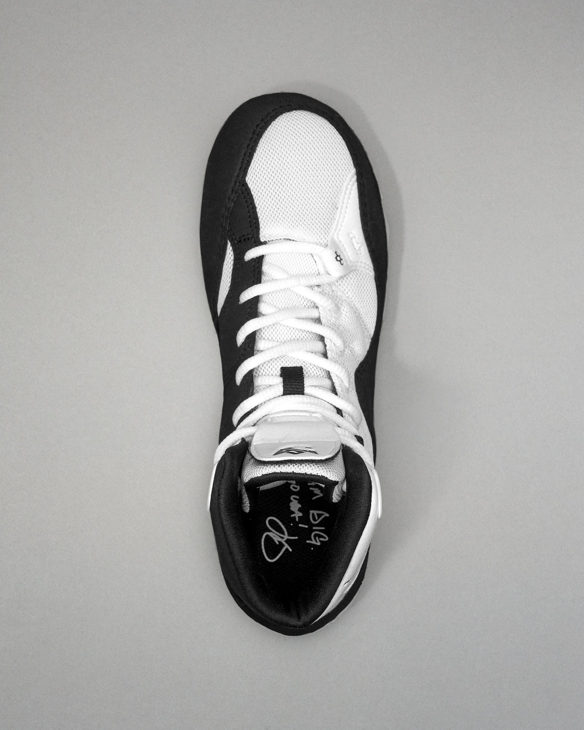 Black and white Jordan Burroughs Wrestling shoes on a gray background