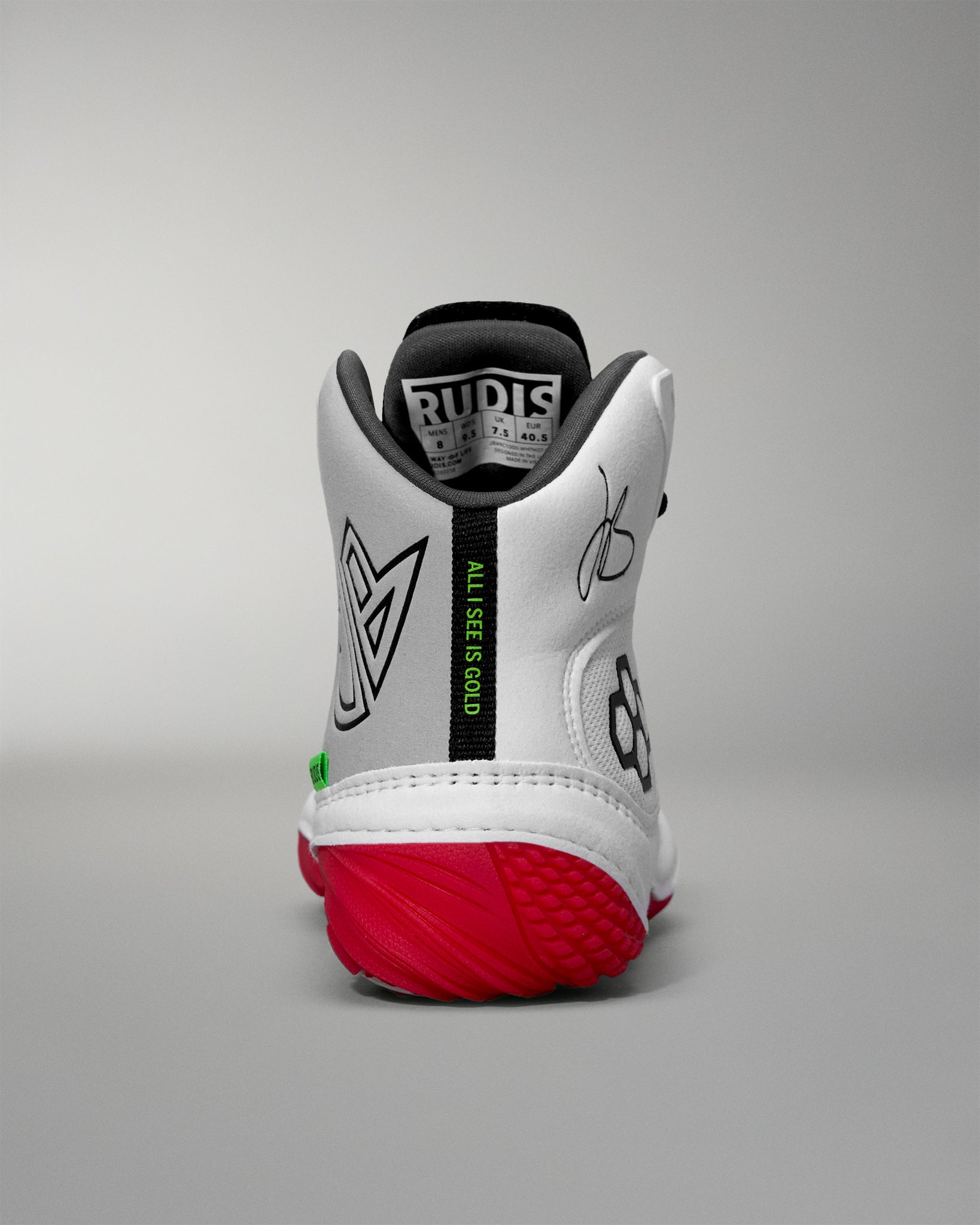 White wrestling shoe with red sole on a gray background