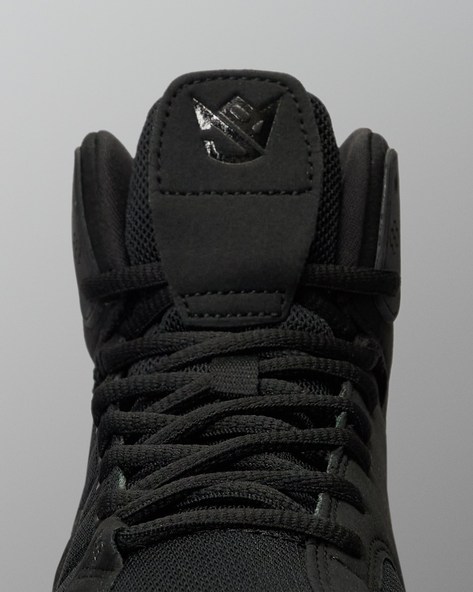 RUDIS JB1 Adult Wrestling Shoe in Dark Shark shown in a close-up front view, highlighting the black lacing system, mesh tongue, padded collar, and tonal JB tongue logo.