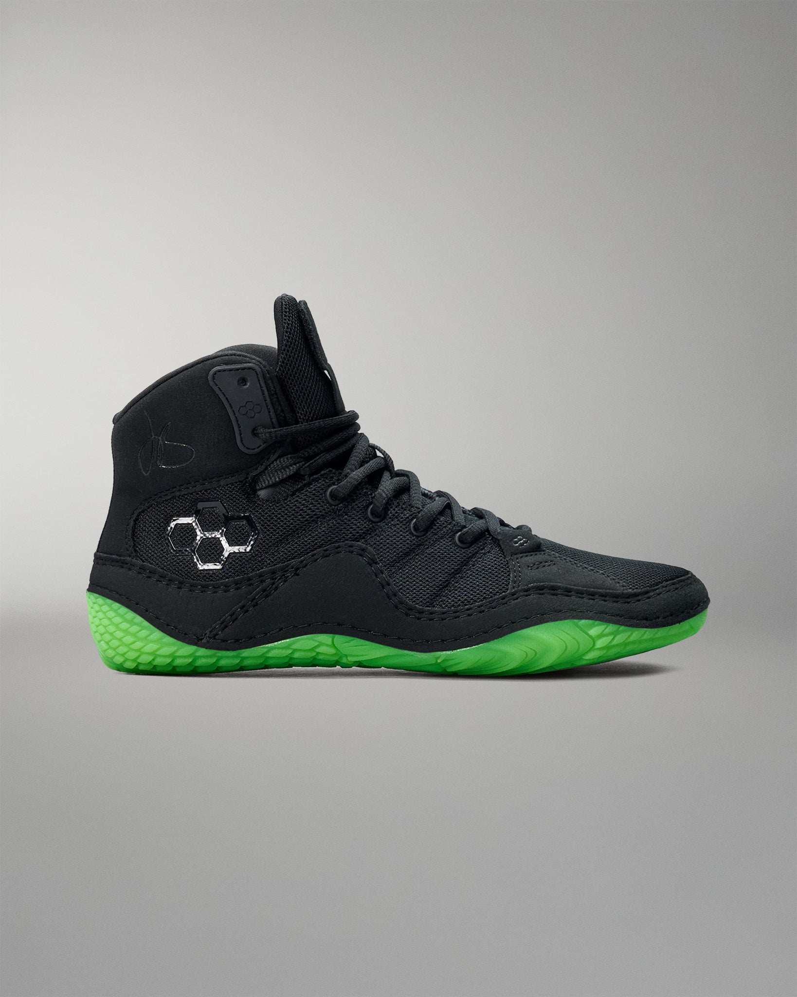 Black Wrestling shoe with green sole on a gray background