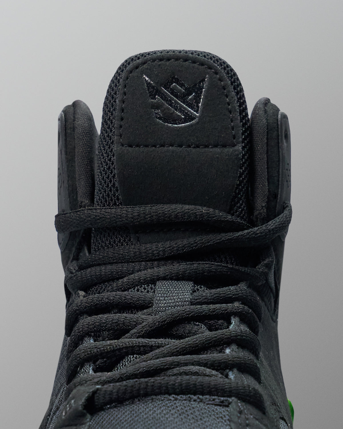 Black Wrestling shoe with brand logo on a gray background