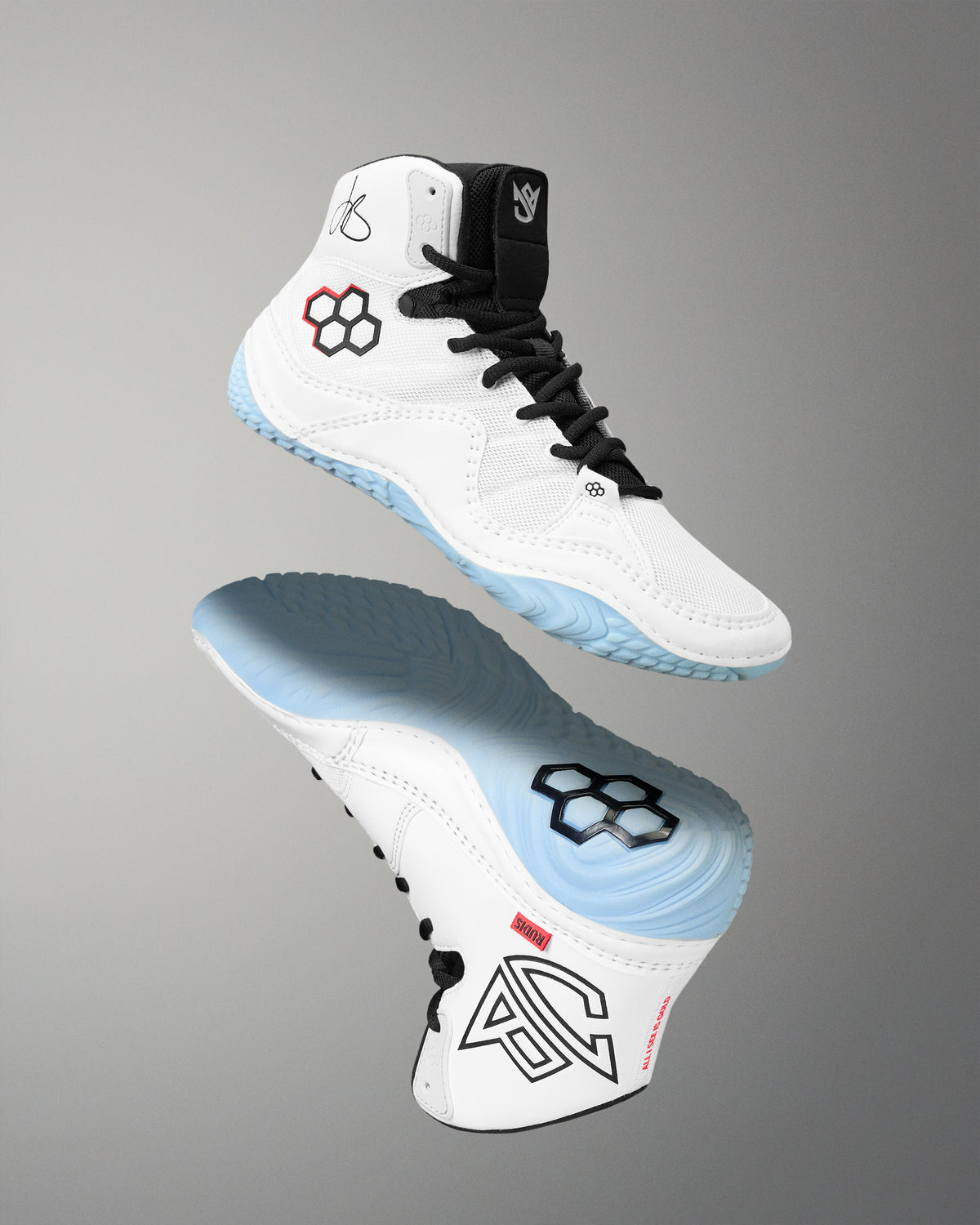 A pair of high-top athletic wrestling shoes shown floating against a smooth gray gradient background. The shoes are primarily white with black laces, black and red geometric logo details, and light blue accents on the sole and heel area.