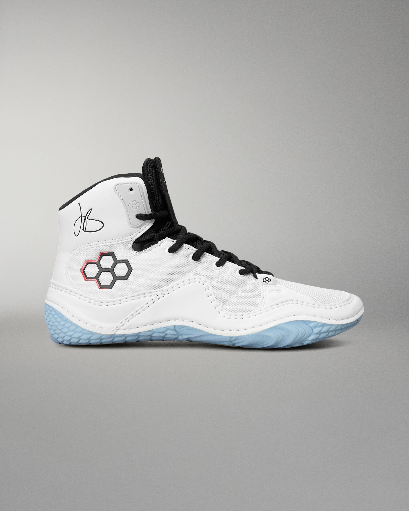 A high-top athletic wrestling shoes in white with black laces, a black and red hexagonal logo on the side, and a light blue textured outsole, shown against a neutral gray background.