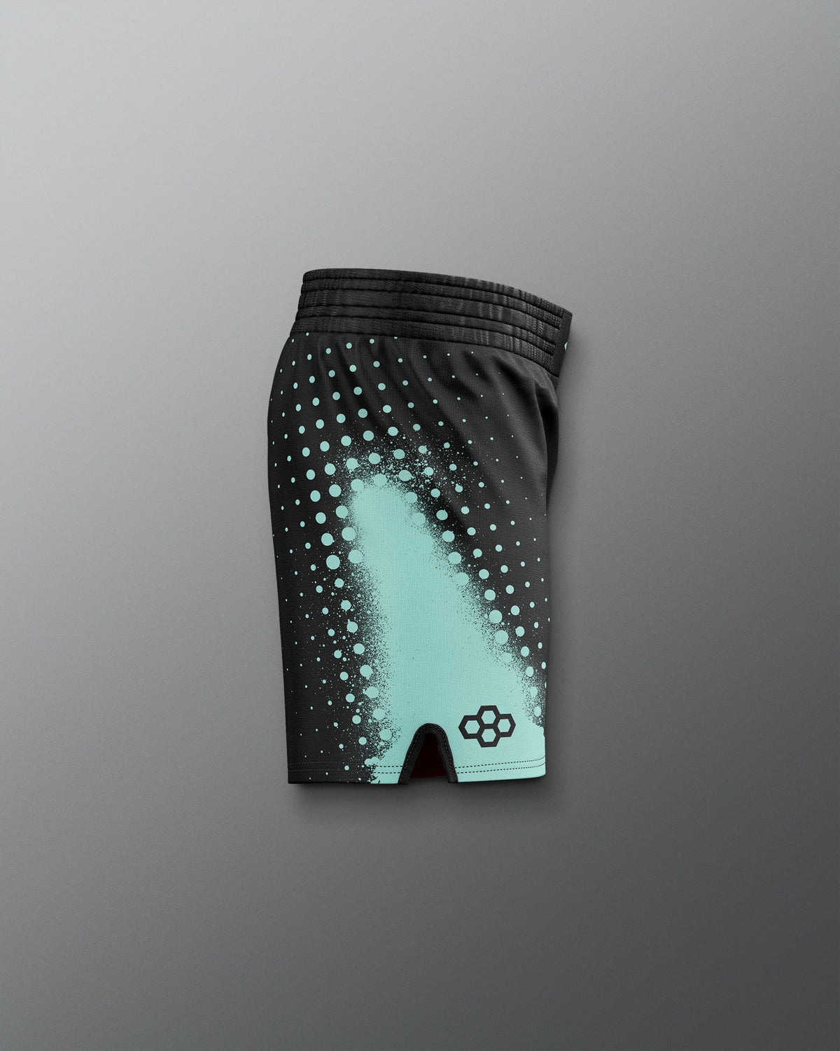 Black athletic shorts with teal pattern on a gray background