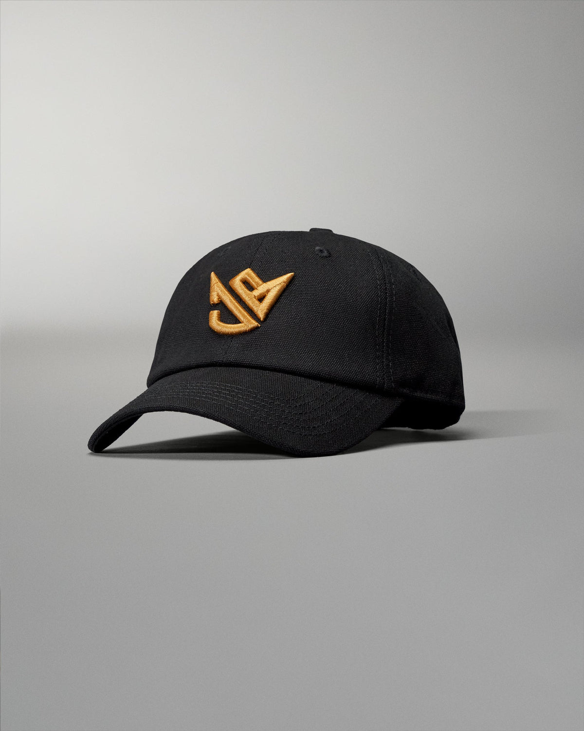 Black cap with gold logo on a gray background